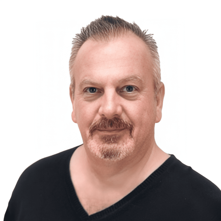 about-2 Man with short hair and beard smiling.