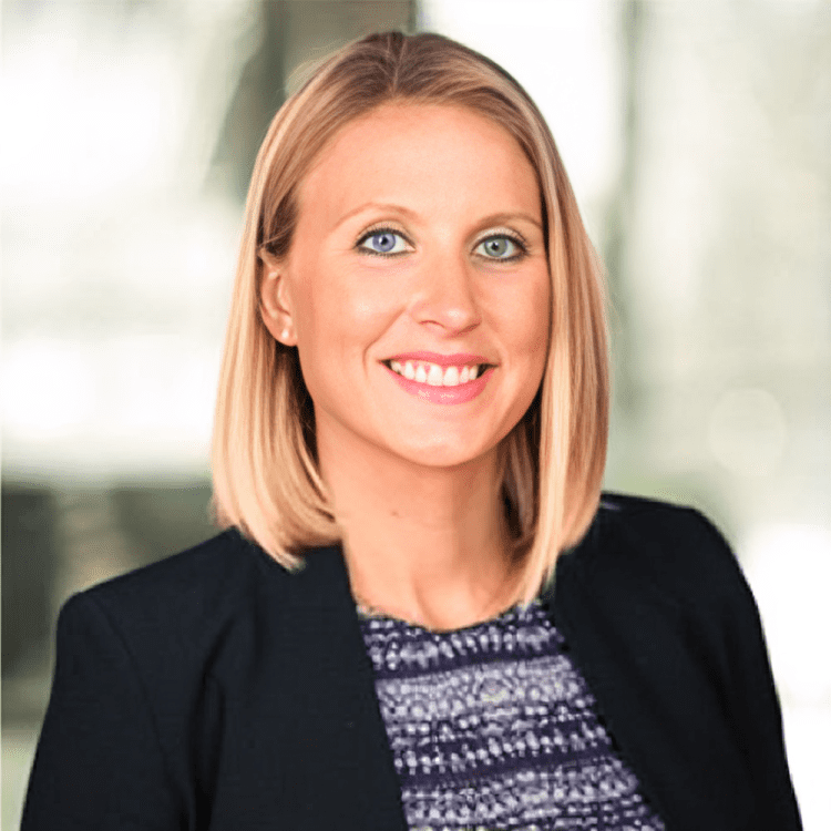 about-3 Smiling woman in professional attire, indoors.