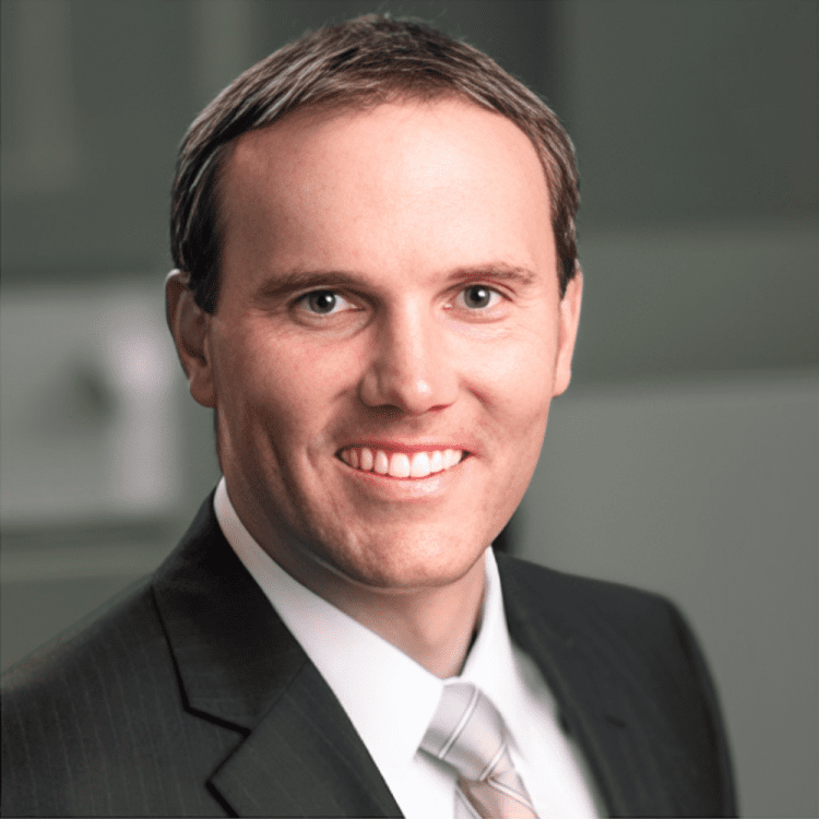 about-5 Smiling man in a suit and tie.