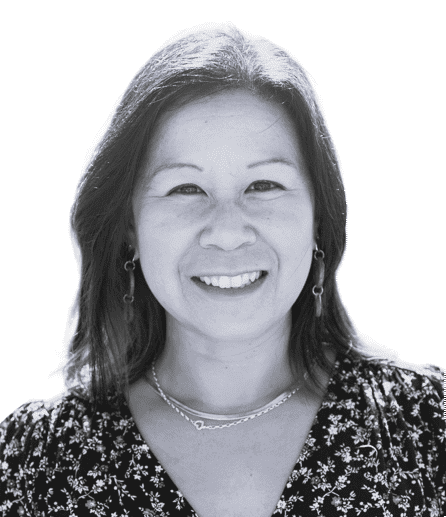 Smiling woman in floral dress portrait.